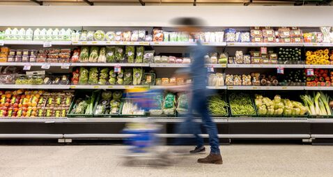 Man shopping at the supermarket - blurred motion