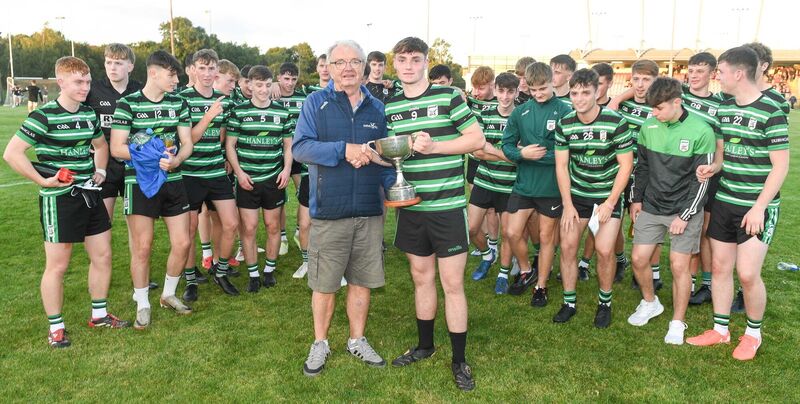 Aidan Luttrell, Rebel Og, presents the cup to Douglas captain Jack O'Brien. Picture: David Keane.  Aidan Luttrell, Rebel Og, presents the cup to Douglas captain Jack O'Brien. Picture: David Keane.