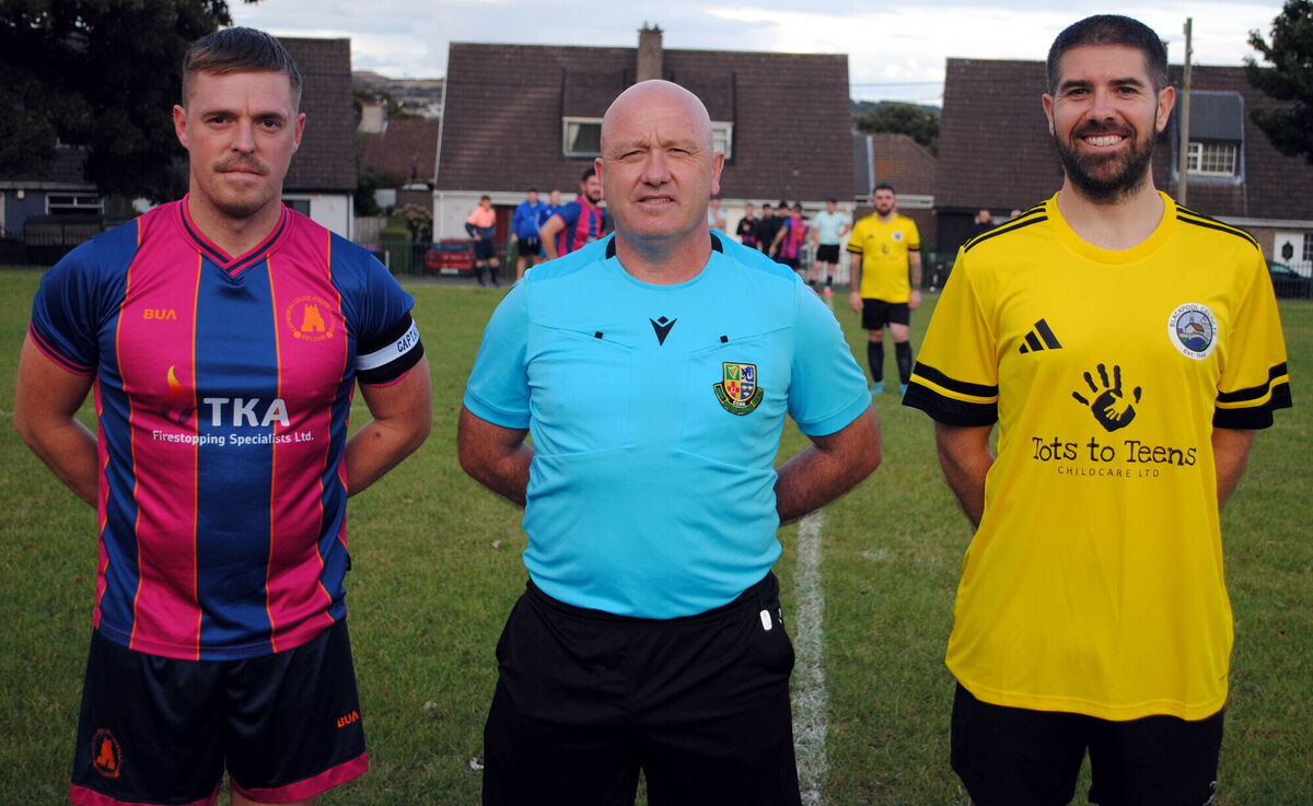 Blackpool Celtic's Craig Horgan (right), with Cathedral Celtic's Jonathan O'Sullivan, accompanied by referee Patrick O'Herlihy. Blackpool Celtic's Craig Horgan (right), with Cathedral Celtic's Jonathan O'Sullivan, accompanied by referee Patrick O'Herlihy.