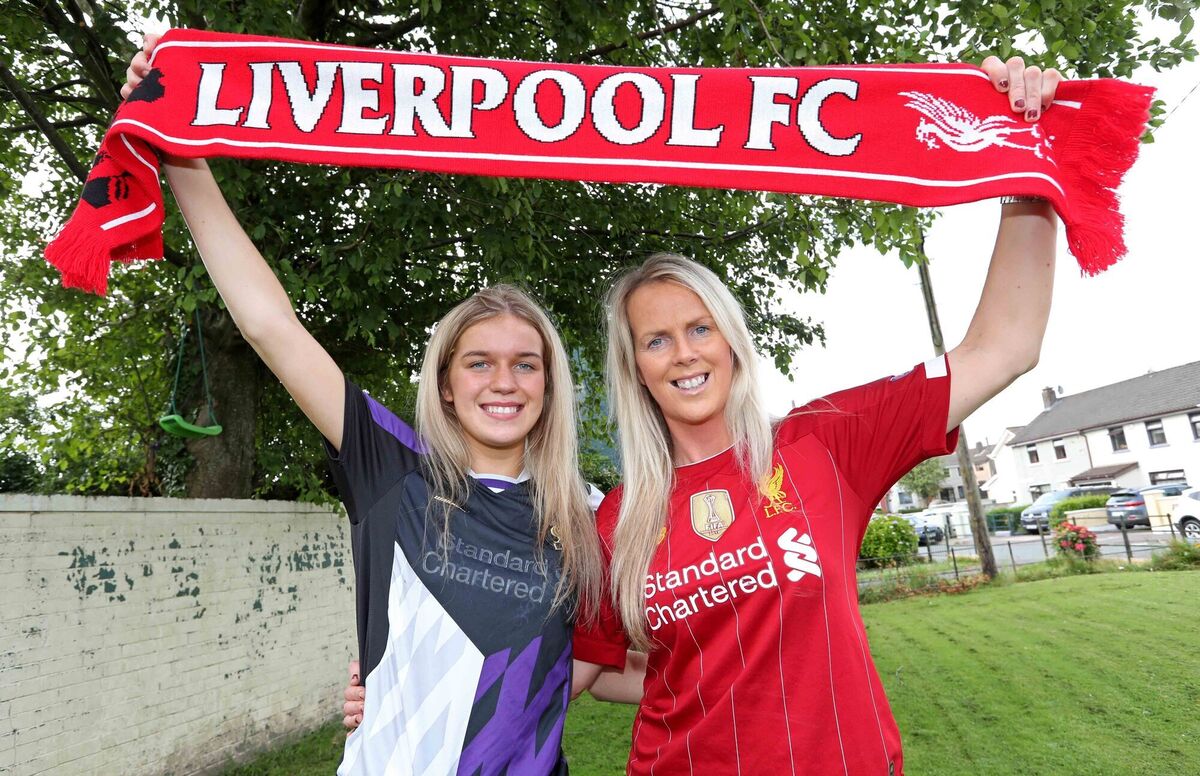 Jesse Mendez, Barbara O'Connell, Liverpool FC supporters, celebrate winning the Premier League, at their home in Ballyphehane, Cork.