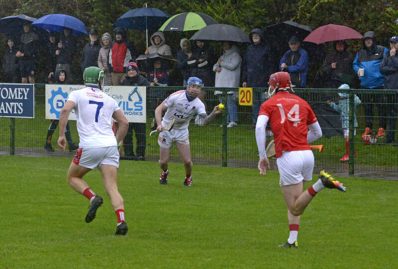 Courcey Rovers' Colm Daly looking for support from Martin Collins chased by Blarney's Cian Barrett. Picture: Denis Boyle