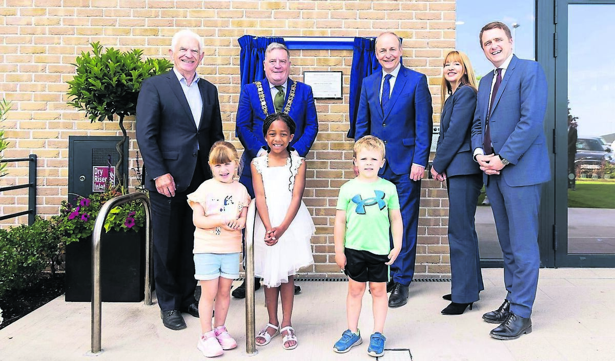 John O’Connor, Chairman Respond;​ former lord mayor of Cork, Cllr. Dan Boyle​; An Taoiseach Micheál Martin.​; Aoife Watters, CEO at Respond​; housing minister James Browne, with ​with children Luna Pereira​, Tiana Hemedy​ and Harvey Connolly, at Jacob's Island, Mahon Point, Cork, marking a significant milestone in one of Cork's largest social and cost rental housing developments, led by Approved Housing Body and service provider Respond. The project will deliver 218 high-quality homes in total. During his visit, the Taoiseach officially opened 69 new social homes already completed and turned the sod on the next phase of 149 Cost Rental homes, due for completion in 2027.Picture: Alison Miles /OSM PHOTO
