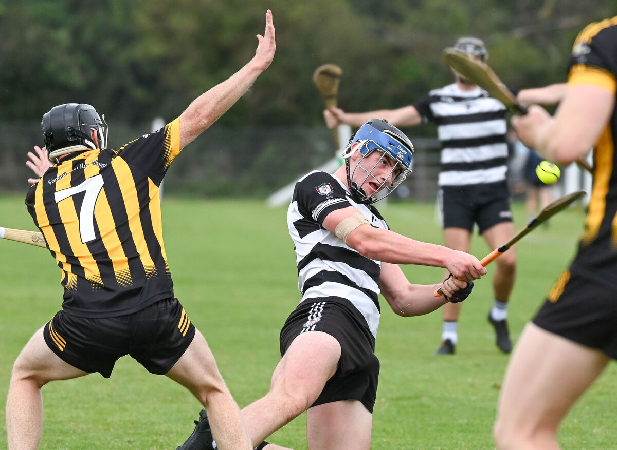  Midleton's Conor Morley shoots from his knees past Russell Rovers' Kevin Tattan. Picture: David Keane.