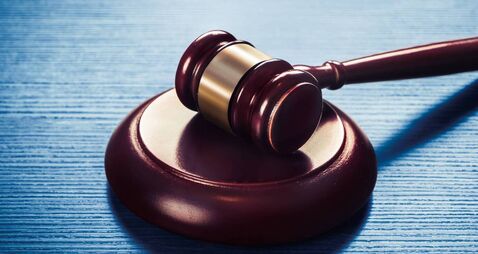 judge gavel on a blue wooden background