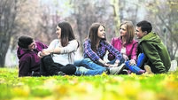 Group of teenage friends having relaxing outdoors