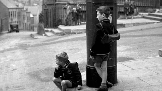 <p class="contextmenu internal_Caption">Two boys from Christian Brothers College wait for a lift home from school during a bus strike in Cork city on September 4, 1947</p>