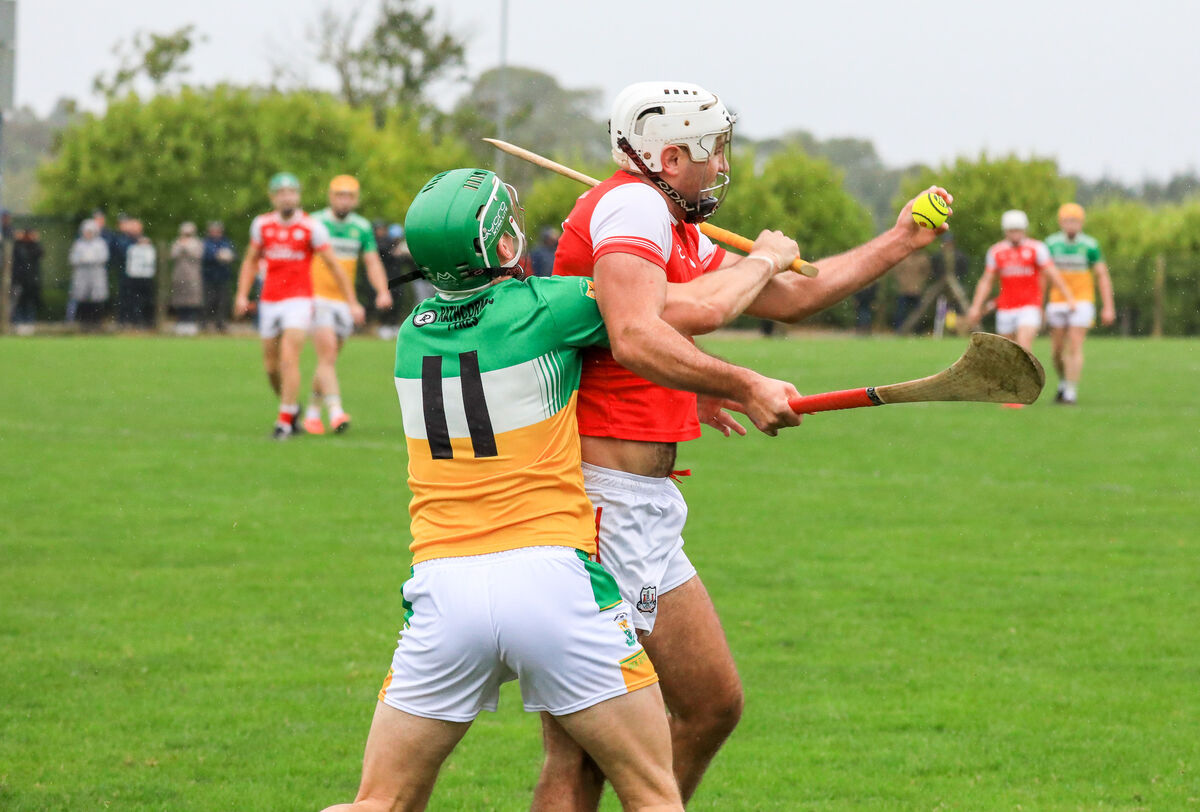 Watergrasshill's Kevin O'Neill is tackled by Rovers player Brian Roche. Picture: David Creedon