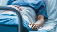 In the Hospital Sick Male Patient Sleeps on the Bed. Heart Rate Monitor Equipment is on His Finger.