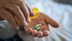 Man hand taking medicine