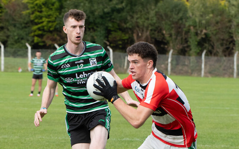 Ballincollig's Darragh O'Mahony holds onto possession ahead of Adam Cantwell of Douglas. Picture: Howard Crowdy Ballincollig's Darragh O'Mahony holds onto possession ahead of Adam Cantwell of Douglas. Picture: Howard Crowdy