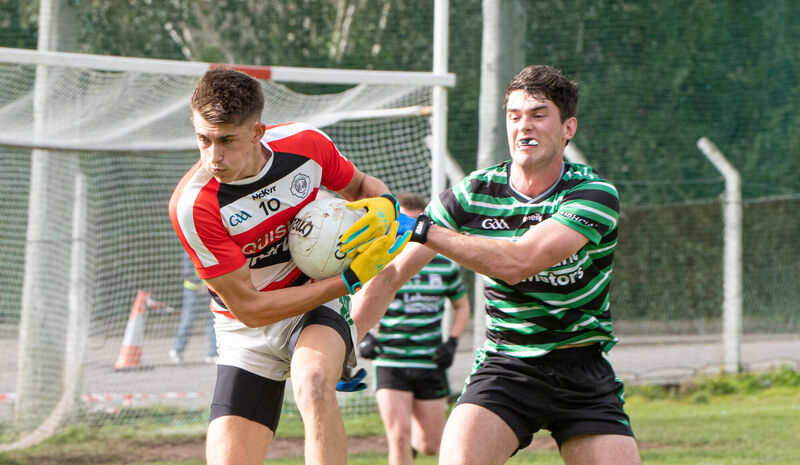 Ben O'Connell of Ballincollig holds onto the ball despite the attention from Shane Aherne of Douglas. Picture: Howard Crowdy