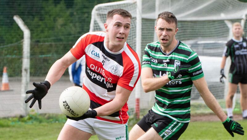 Ballincollig's Luke Fahy about to hand-pass from Douglas' Kevin Shanahan. Picture: Howard Crowdy