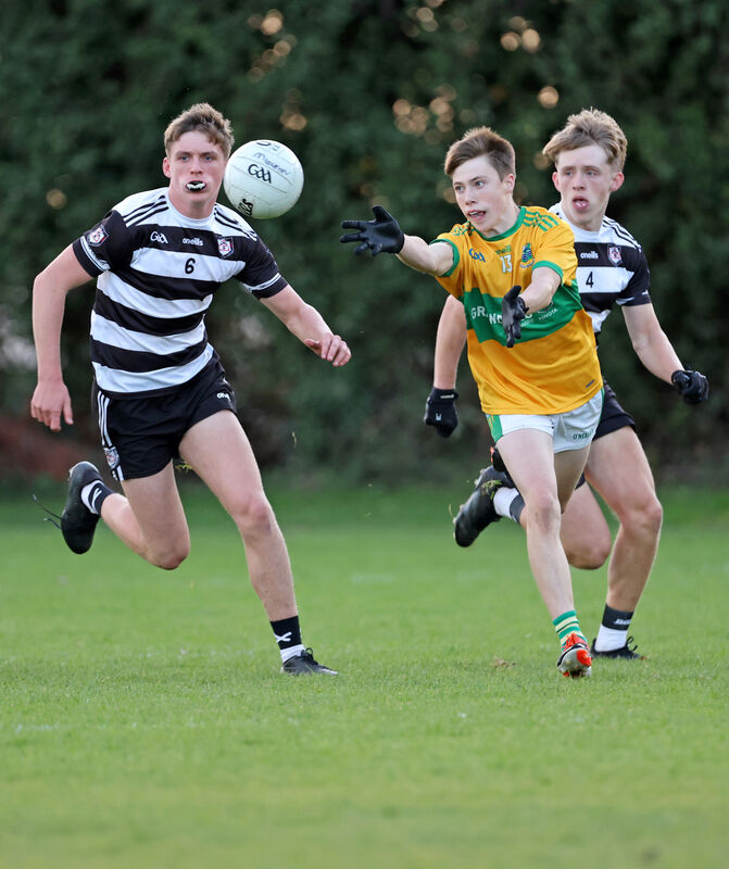 Finn Cahill and Joshua Quill, Midleton chase after Aidan McCarthy, Glanmire as he gets the handless away. Picture: Jim Coughlan. Finn Cahill and Joshua Quill, Midleton chase after Aidan McCarthy, Glanmire as he gets the handless away. Picture: Jim Coughlan.