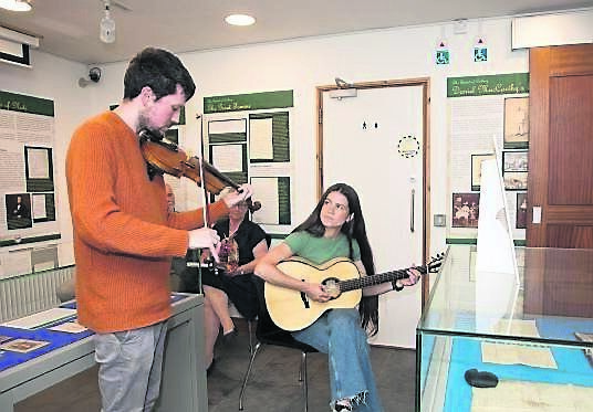 Macdara Ó Faoláin, fiddle, and Victoria Adiiye, on guitar, entertain guests at the opening of the Danial MacCarthy Glas exhibition at the City and County Archives in Blackpool. 	Picture: David Creedon
                    