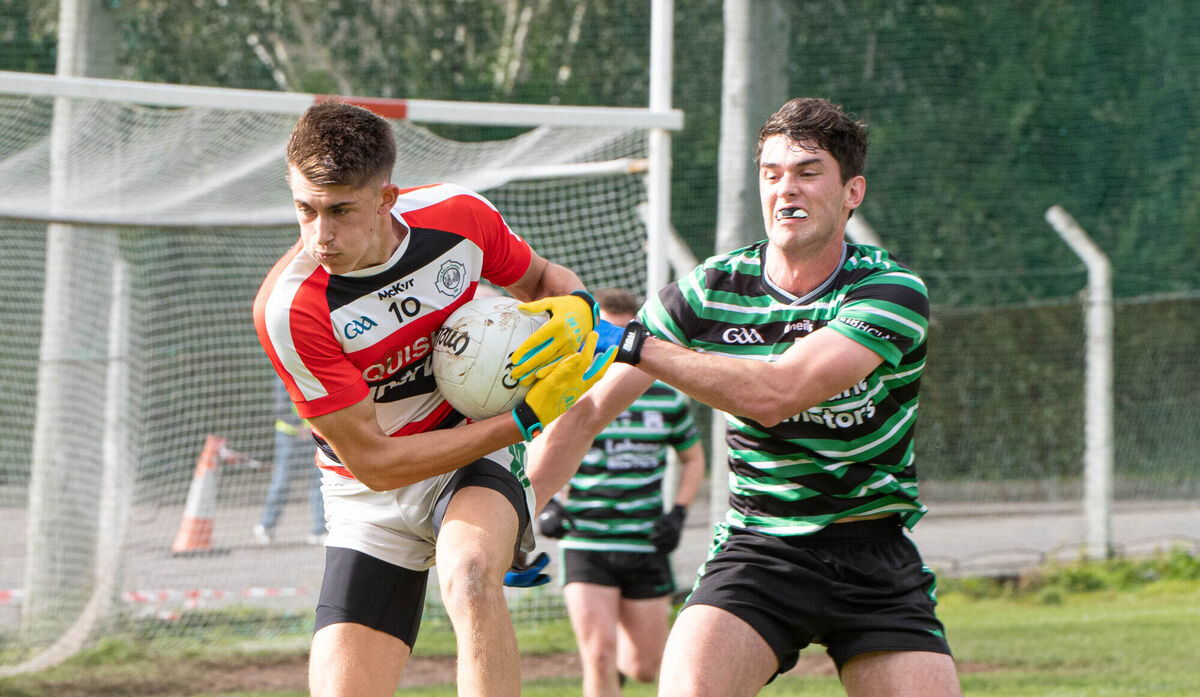 Ben O'Connell of Ballincollig holds on to the ball despite the attention from Shane Aherne of Douglas. Picture: Howard Crowdy