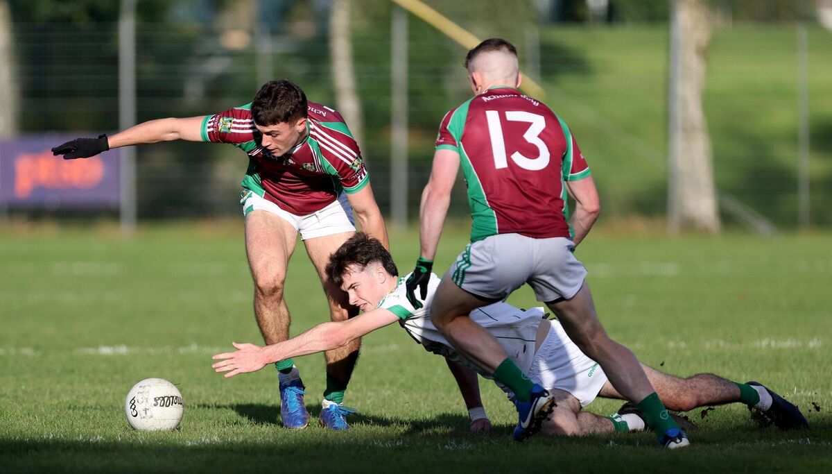 Pauric O'Sullivan and Matthew Bradley, Aghabullogue, tackling Cian Hegarty, Aghada. Picture: Jim Coughlan.