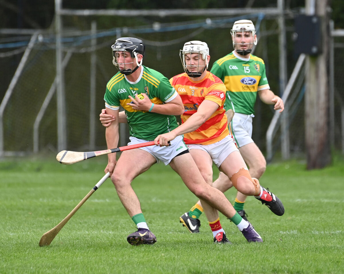  Eoghan Collins, Newcestown, getting in a tackle on Turlough O'Neill of Newtownshandrum in their Co-Op Superstores Premier SHC match at Blarney. Picture: Dan Linehan