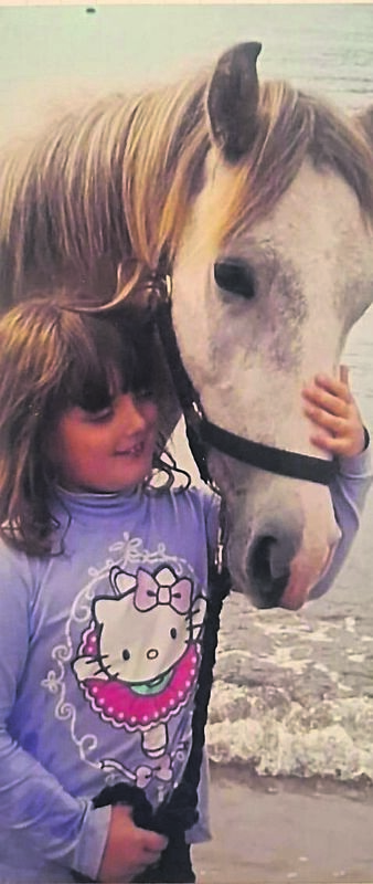 Samantha with the horse soon after her family adopted him. Samantha with the horse soon after her family adopted him.