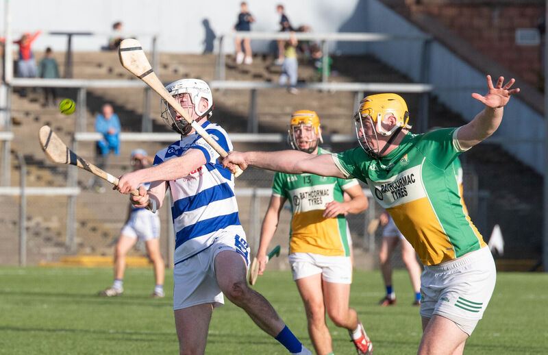 Inniscarra's Daniel Murphy strikes the sliothar despite the attempt to block from Bride Rovers Cillian Tobin during the SAHC quarter final match in Pairc Ui Rinn. Picture: Howard Crowdy