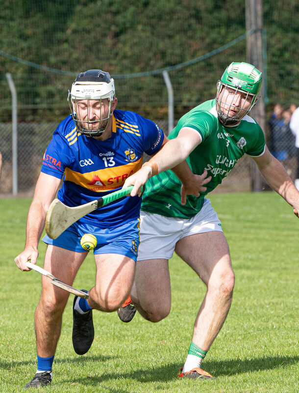 Carrigaline's David Drake reaches out for the ball despite the attention from Ballincollig's Jordan Murray during the PIHC match in Riverstick. Picture: Howard Crowdy