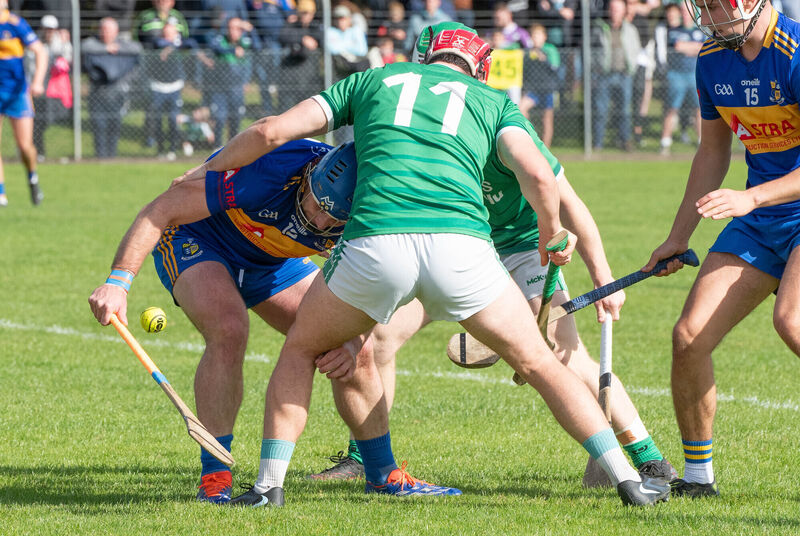 Carrigaline's Rob O'Shea about to reach out for the ball ahead of Ballincollig's Tadhg O'Connell. Picture: Howard Crowdy