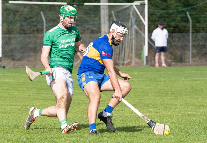 Carrigaline's David Drake about to gather the ball ahead of Ballincollig's Jordan Murray during the PIHC match in Riverstick. Picture: Howard Crowdy