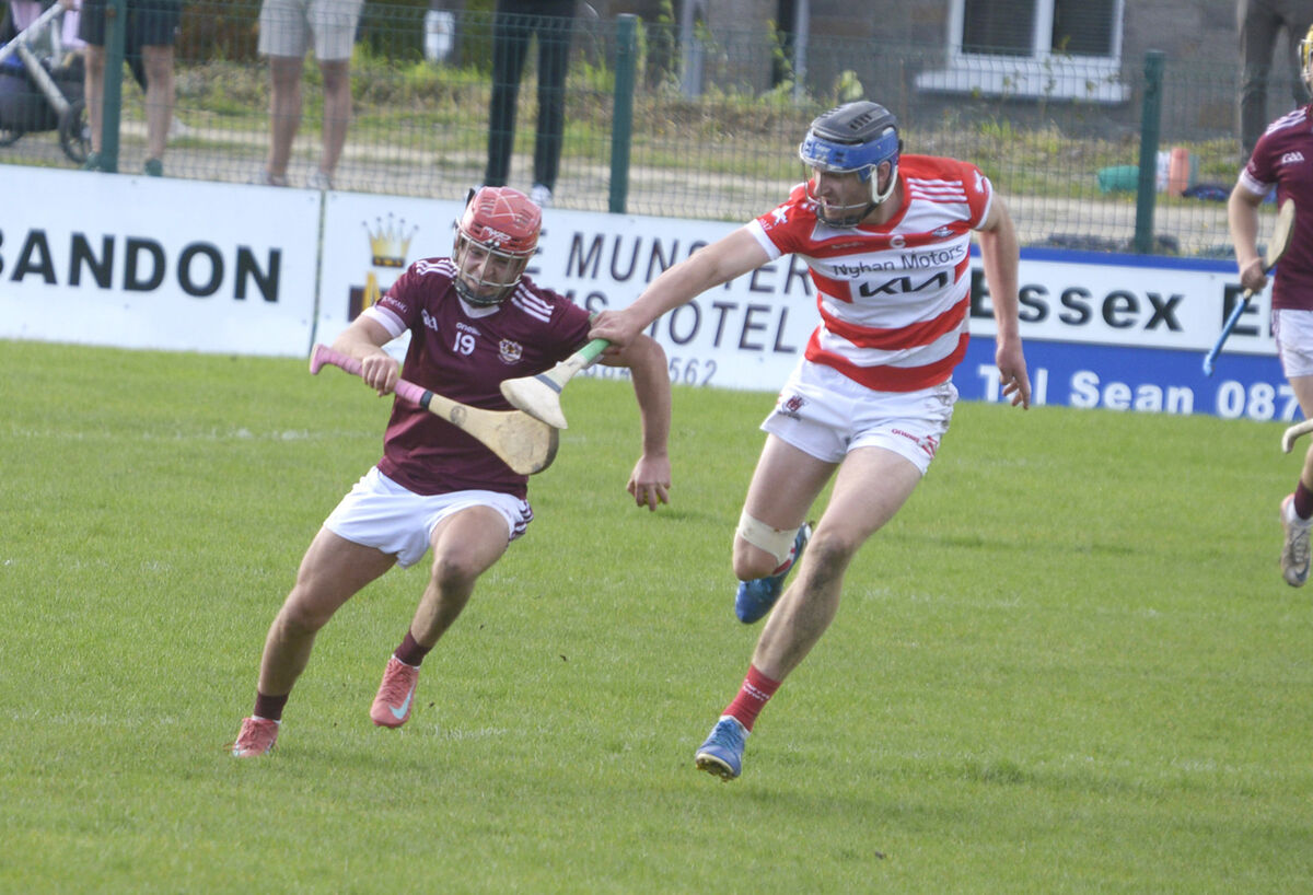 Bishopstown's Darragh O'Donovan holding off the tackle of Courceys' Colin Roche. Picture: Denis Boyle