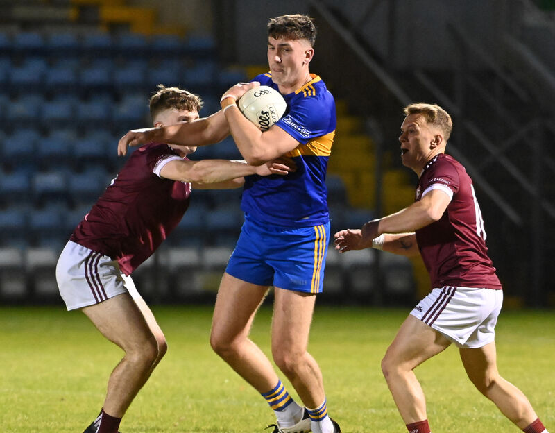 Carrigaline's Brian Coakley is tackled by Bishopstown's Kevin Murphy and Brian Clifford during the McCarthy Insurance Group SAFC game in 2023. Picture: Eddie O'Hare