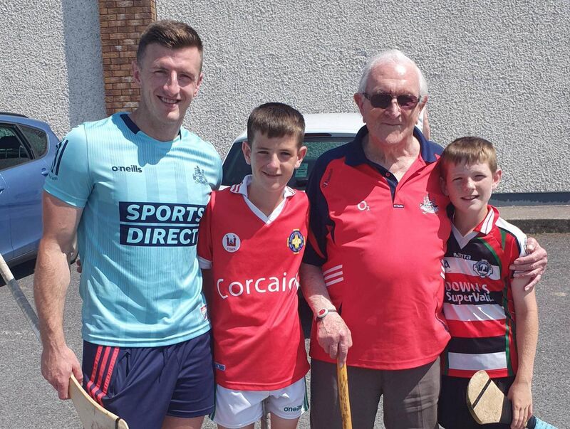 Eddie Hogan and his great-grandsons Tadhg Murphy and Daithí Murphy in Glen Rovers with Patrick Horgan after a hurling camp.