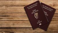 An Irish passport gives citizens of Ireland, a top view of passports on a wooden table