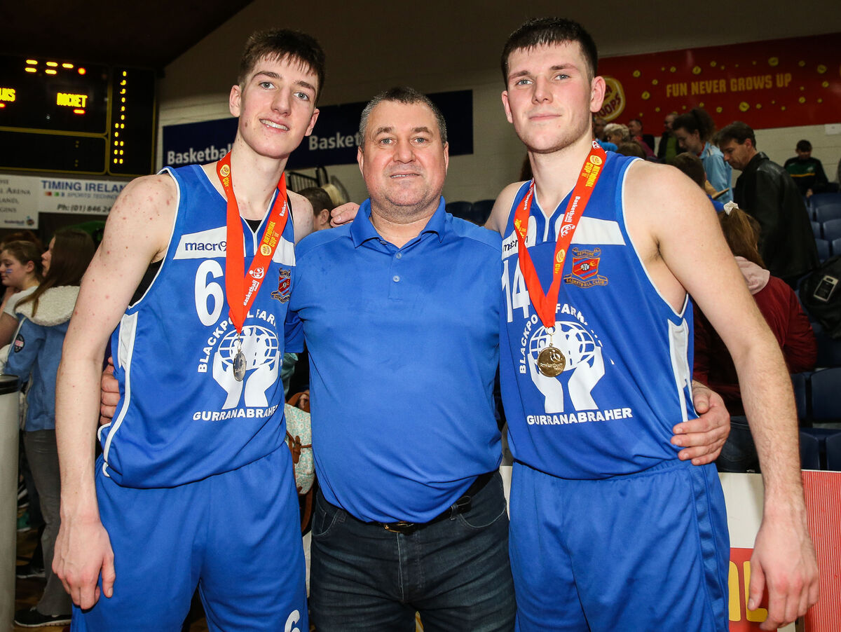Neptune players Cian and Adam Heaphy celebrate with their father Ger. Picture: INPHO/Gary Carr