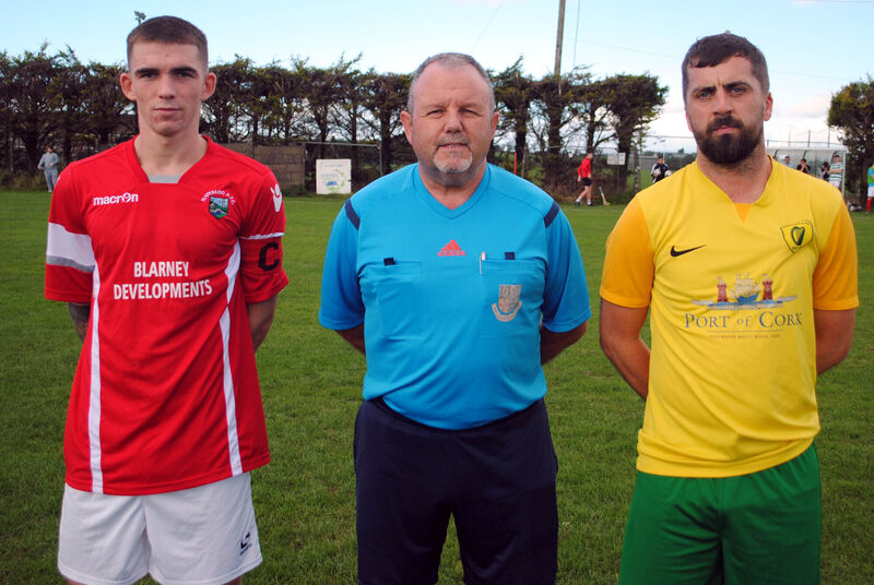 Waterloo's captain Jack Homan (left), with Hibernians' Aaron Hickey, accompanied by referee Paul O'Sullivan.
