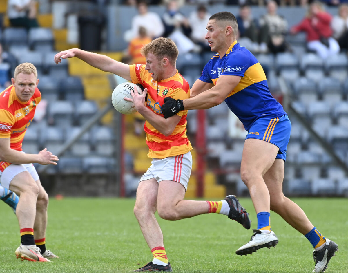 Newcestown's Seamus O'Sullivan is tackled by Carrigaline's Niall Quirke. Picture: Eddie O'Hare