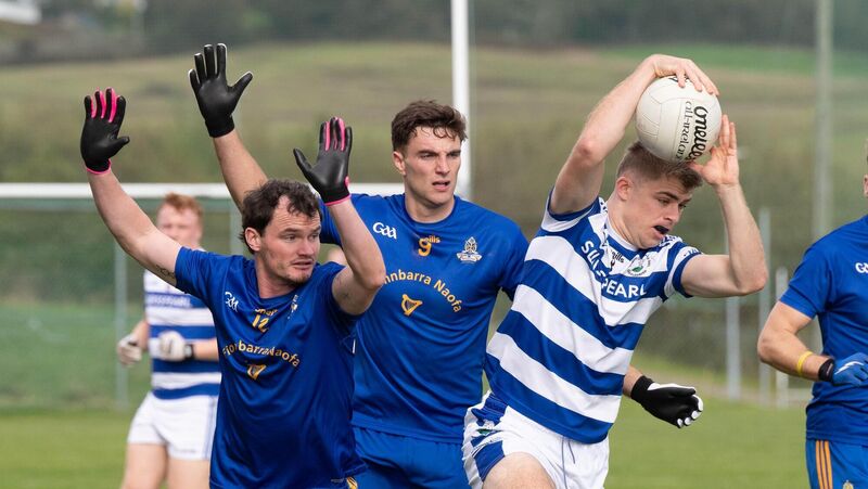 Castlehaven's Andrew Whelton holds on to the ball ahead of Conor Dennehy and Brian Hayes of St Finbarr's. Picture: Howard Crowdy