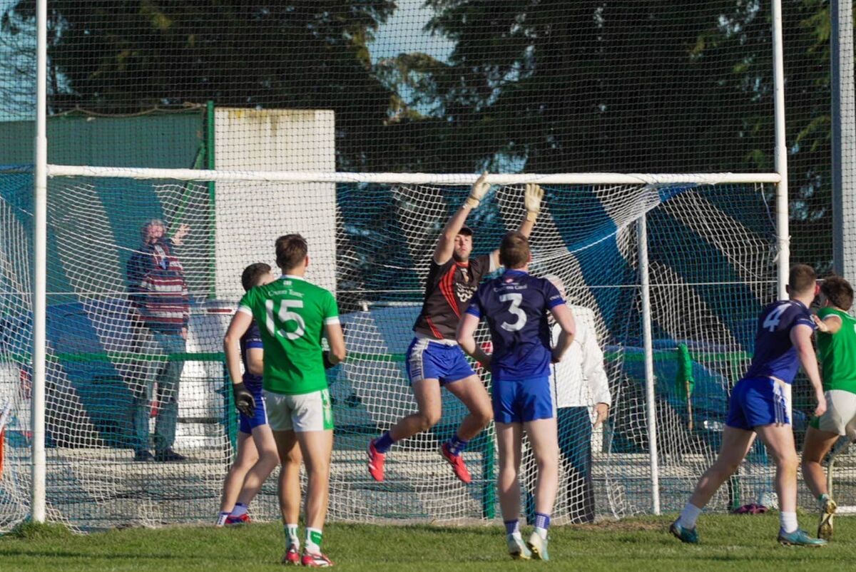 Goalkeeper Patrick Doyle of Knocknagree - who played in navy - tries to stop a score from the green-clad Kanturk. Picture: Noel Sweeney