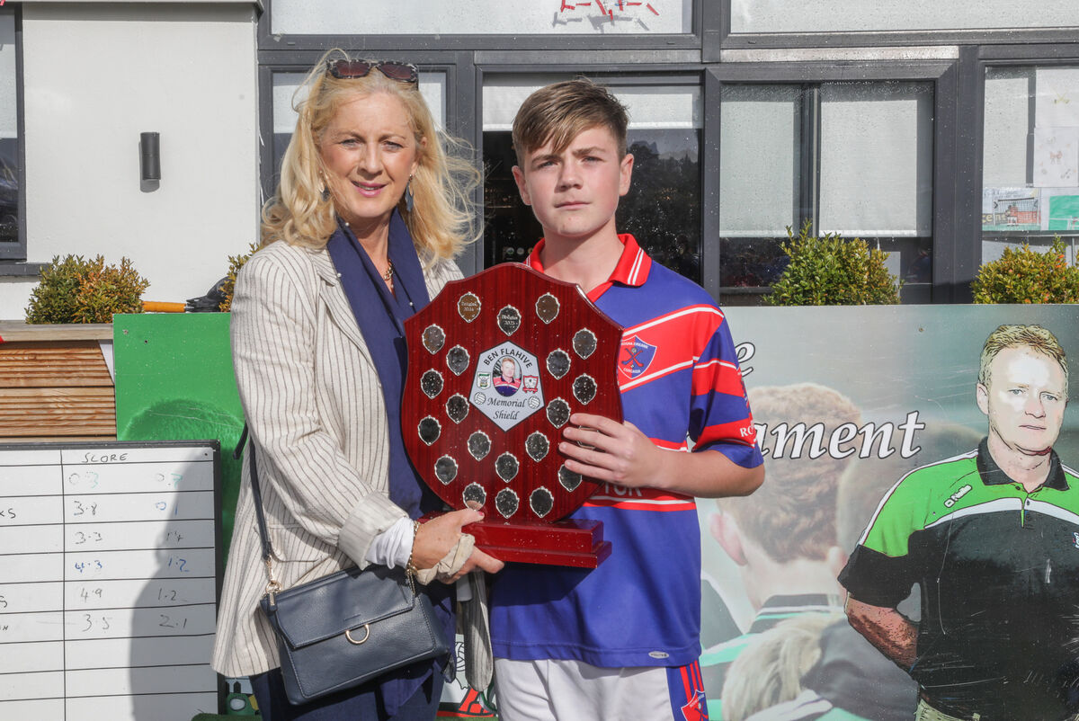 Pauline Flahive presents the Ben Flahive U14 Football Memorial Shield to Fionn Jeffers, captain of Erin's Own. Picture: David Creedon