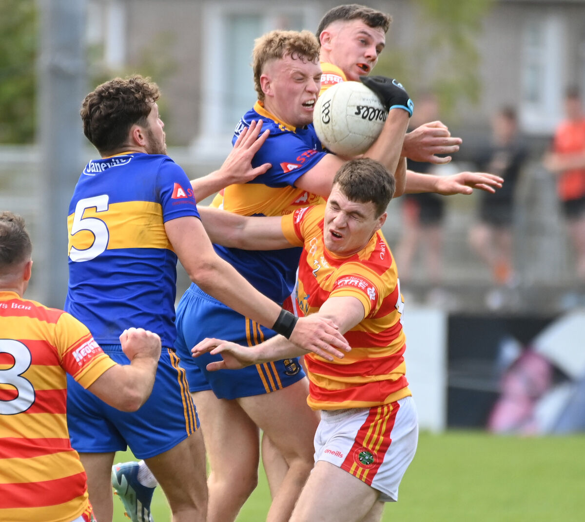 Carrigaline's Patrick Mellet goes high with Newcestown's Eoghan Collins and David Buckley. Picture: Eddie O'Hare