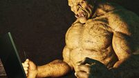 Internet troll: angry ogre pounding fists on desk while using laptop computer