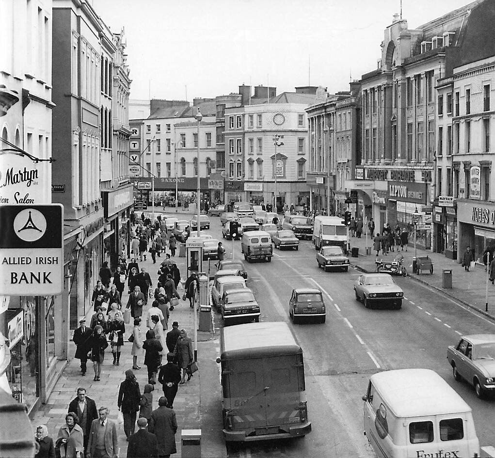 The changing face of Patrick Street in the 1970s, with Minis, Ford Escorts and Volkswagens on the road. ‘Doing Pana ’in those days was a common routine