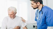 Senior patient suffering from heart attack . doctor care about patient with heart pain