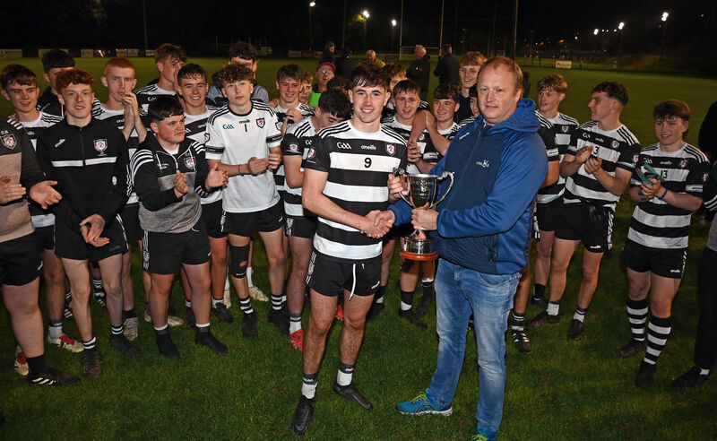 Peter Watson, chairperson of Rebel Óg, presents the trophy to Midleton captain Ciarán Kelly. Picture: Eddie O'Hare