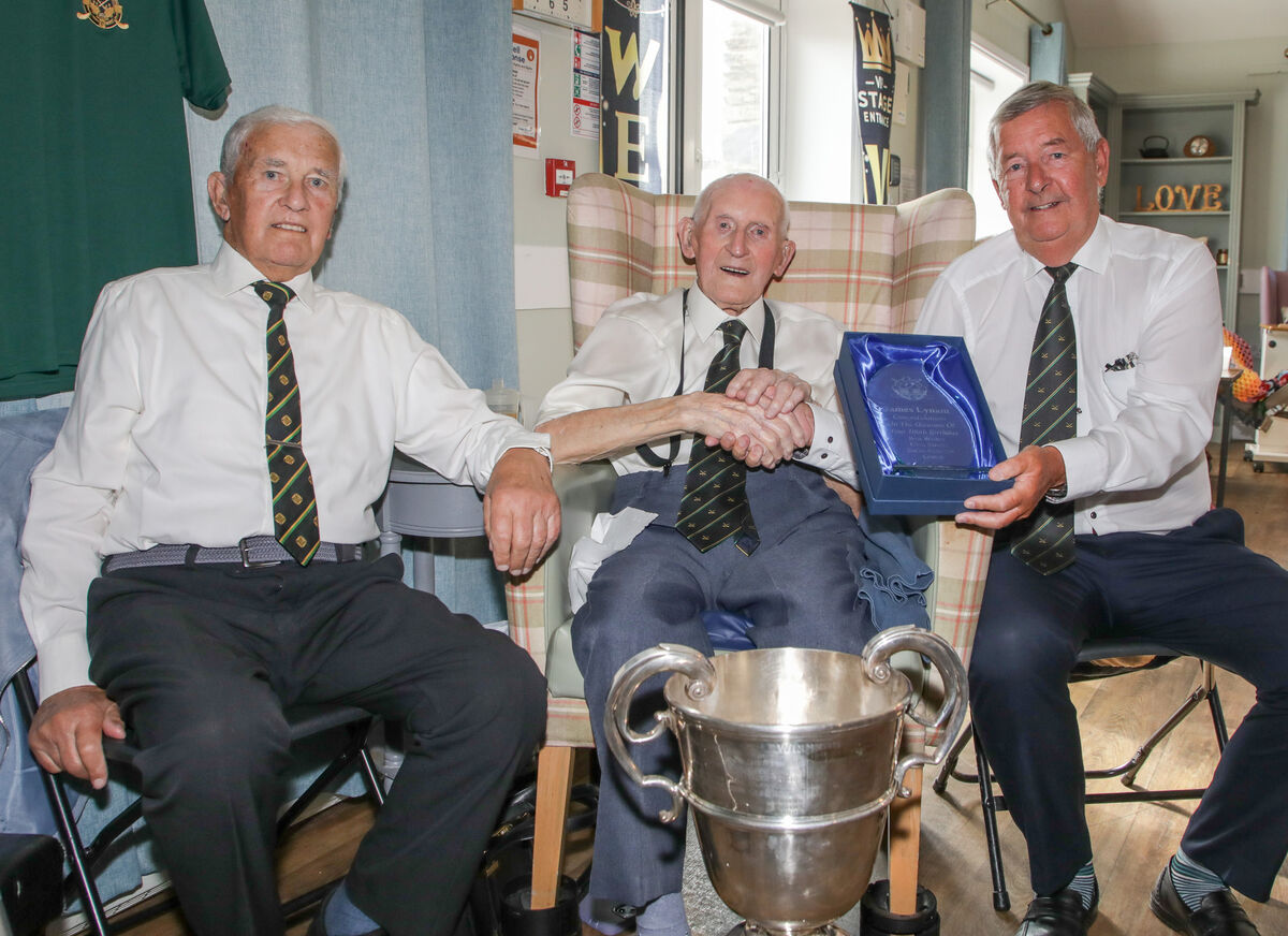 Glen Rovers president John O'Callaghan makes a presentation on behalf of the Glen Rovers Social Initiative Choir to Jimmy Lynam on his 100th birthday, also in picture is his brother Noel Lynam. Picture: David Creedon