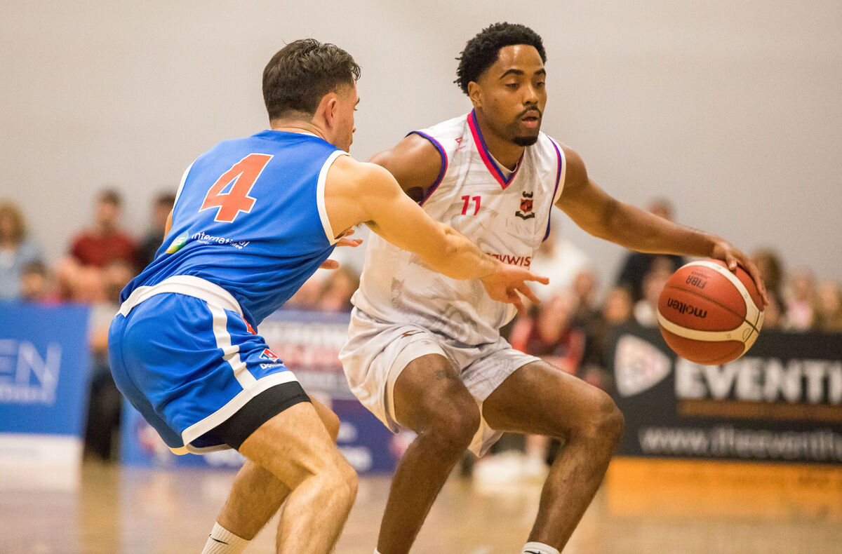 Neptune's Cameron Glover tries to get past Demons Scott Hannigan. Picture: David Creedon