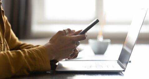 Digital devices on office workplace table of young business woman