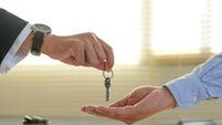A real estate agent gives a client the house keys after signing a real estate contract with an approved mortgage form. About off