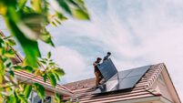 Go Green: Young Homeowners installing Solar Panels on a Suburban Western USA Home