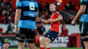 <p>Munster's Jack Crowley takes a drop kick at goal </p>