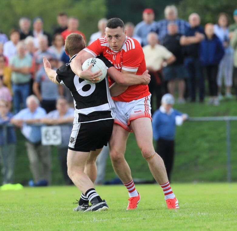 Uibh Laoire Cathal Vaughan is tackled by Castletownbere's Trevor Collins during their PIFC clash in Kilkeal. Picture: Anne Marie Cronin