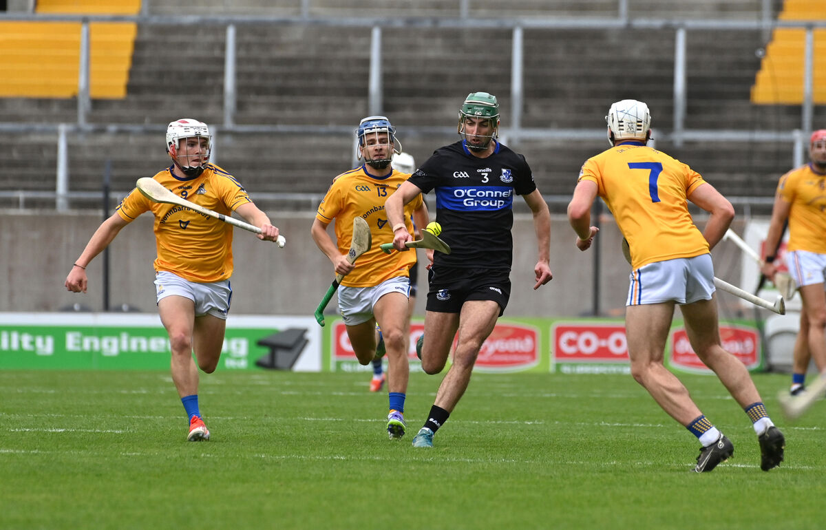 Cillian Roche of Sarsfields bursting past St Finbarr's players John Wigginton Barrett and Sam Cunningham. Picture: Dan Linehan