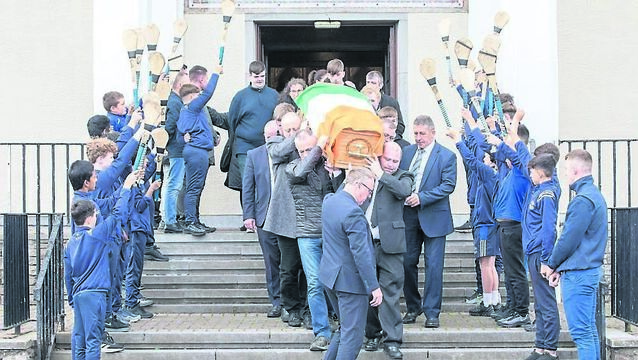 <p>Pupils from the North Monastery national school provide a guard of honor as mourners carry the coffin of Don O'Leary out after his funeral mass at the Church of the Resurrection Farranree, Cork. - Picture: David Creedon</p>